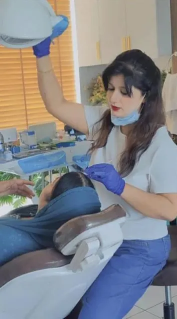 Dr. Arti Kumari cleaning a patient's teeth